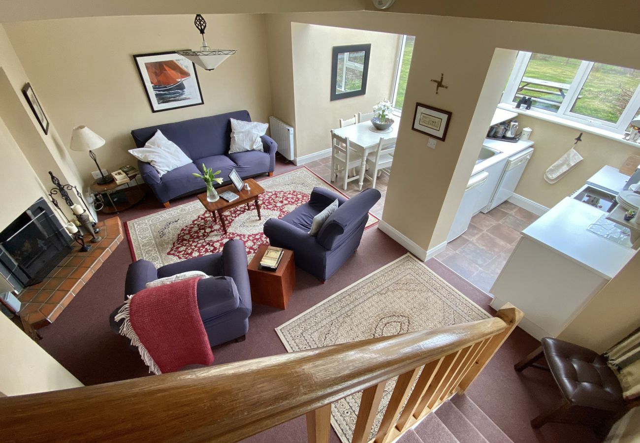 Clifden Glen Holiday Village No 30. Living room. Open plan comfortable sofas, open fire, TV.