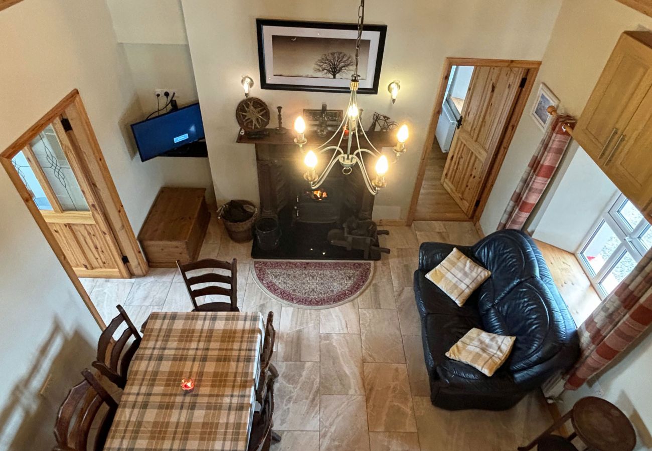 Conroy's Cottage Carna. Mezzanine. Dining for 6. Open plan dining lounge. View from Mezzanine. Sofa, dining, open fire. 