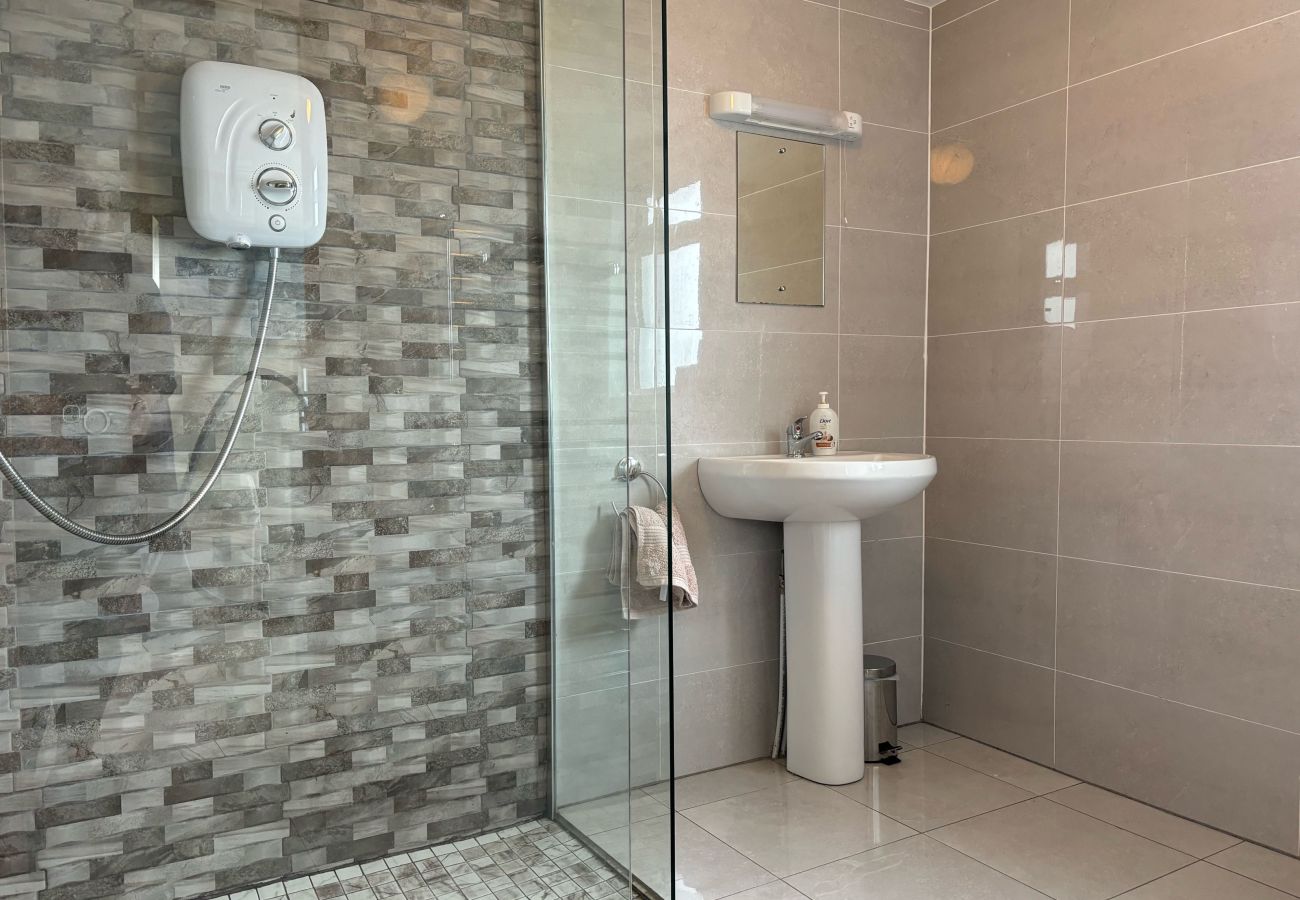 Conroy's Cottage Carna. Modern large shower, WC, sink heated rail. Modern tiled decor.